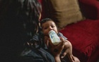 Ashley Aguirre feeds her 1-month-old son, Deandrew Colins, at their home in San Antonio, May 10, 2022. (Kaylee Greenlee Beal/The New York Times)